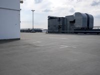 a boat is parked in an empty parking lot near an air port on the water