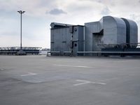 a boat is parked in an empty parking lot near an air port on the water