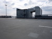 a boat is parked in an empty parking lot near an air port on the water