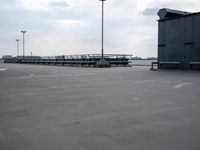 a boat is parked in an empty parking lot near an air port on the water