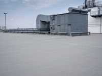 a boat is parked in an empty parking lot near an air port on the water