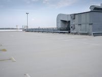 a boat is parked in an empty parking lot near an air port on the water