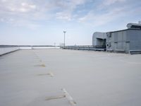 a boat is parked in an empty parking lot near an air port on the water