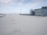 a boat is parked in an empty parking lot near an air port on the water