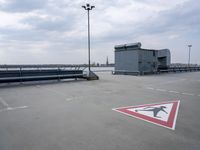 a boat is parked in an empty parking lot near an air port on the water