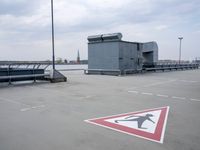 a boat is parked in an empty parking lot near an air port on the water