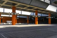 several light bulbs are located underneath an outdoor parking lot at the airport with benches on the pavement