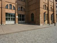 a building with a number of windows on one side and brick walls on the other