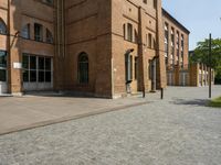 a building with a number of windows on one side and brick walls on the other