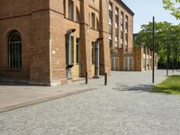 a building with a number of windows on one side and brick walls on the other