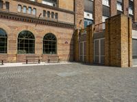 a building with a number of windows on one side and brick walls on the other