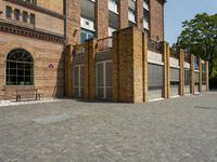 a building with a number of windows on one side and brick walls on the other