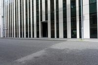 a tall building with many windows is seen from the side of the street with a fire hydrant