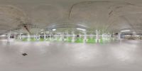 a fisheye view of the indoor area at a skate park at night with people in the foreground