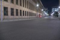 an empty street with tall buildings in the background at night time's most visible light