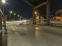 a long exposure photo of an empty street at night with blurred lights on the street