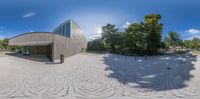 a circular panoramic view of a public building with a park and trees surrounding