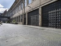 the empty road in front of an industrial building on a sunny day, with lots of windows