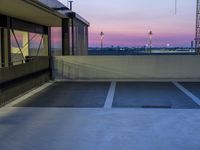 the view over the street of a parking garage from the rooftop area in a city