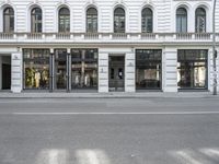 the outside view of a storefront, with a bicycle in front of it and a street