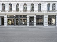 the outside view of a storefront, with a bicycle in front of it and a street