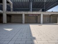 a empty parking garage with empty area in the background, in an urban setting of concrete and metal