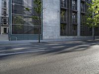 the side walk near a sidewalk next to a building in the city with glass windows