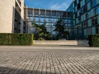 a street and sidewalk area that looks like a courtyard with building designs on each one