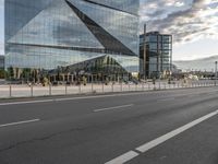 a street in front of a building that has multiple glass on it and it looks nice