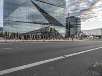 a street in front of a building that has multiple glass on it and it looks nice