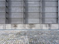 an image of a large industrial building with a brick ground, door and walls in the back