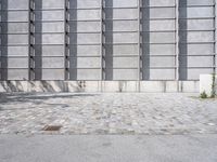 an image of a large industrial building with a brick ground, door and walls in the back