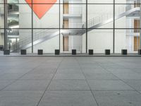 a large glass building with a metal staircase leading up to it's glass wall