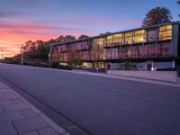 the sunset shines brightly in front of a building and street with steps leading up to it
