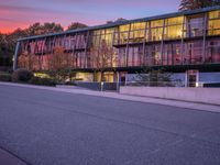 the sunset shines brightly in front of a building and street with steps leading up to it