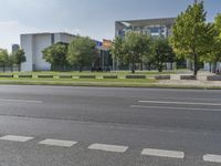 street view of an empty city with buildings in the background and a parked car on the curb