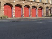 a red fire hydrant sitting on the side of the road with two red fire department doors