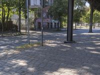 a person is walking and riding a bike near an outdoor area with several brick sidewalking on the ground