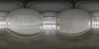 a view from under the inside of an open area in concrete domes, with the ceiling and columns showing