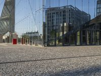 the reflection of an office building in a glass walled entryway is seen in a mirror - glass photo