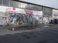 a photo of a city street with a bunch of graffitti on a wall