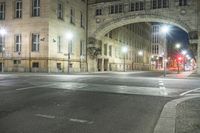 a photo taken in a city at night of a street corner with a pedestrian crosswalk crossing a road