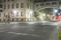 a photo taken in a city at night of a street corner with a pedestrian crosswalk crossing a road