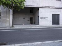 a building has a closed door and sign on the side of it with traffic cones next to it