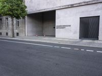 a building has a closed door and sign on the side of it with traffic cones next to it