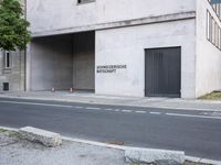 a building has a closed door and sign on the side of it with traffic cones next to it