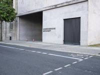 a building has a closed door and sign on the side of it with traffic cones next to it