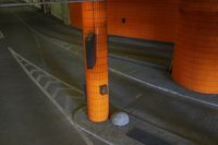 an empty area with a pole at the bottom and another in the background with some paint