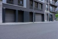 there is a skate board parked on the curb of a city street with buildings on both sides