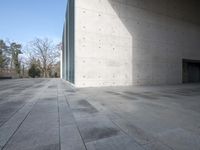 there is a concrete floor with a square pattern of stone that has rounded ridges and squares on it